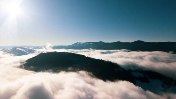 istock Beautiful landscape with mountain peaks covered with snow and clouds 1203714655