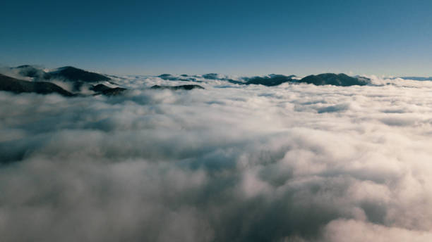 istock Beautiful landscape with mountain peaks covered with snow and clouds 1203714681