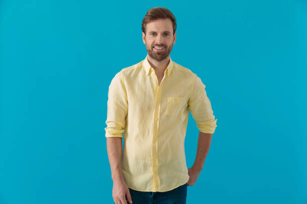 istock Casual man smiling with his hand in his rear pocket 1203714744