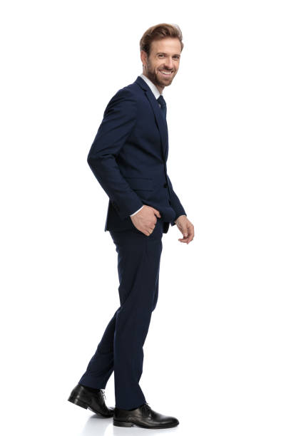 istock happy young businessman in navy blue suit smiling 1203715306