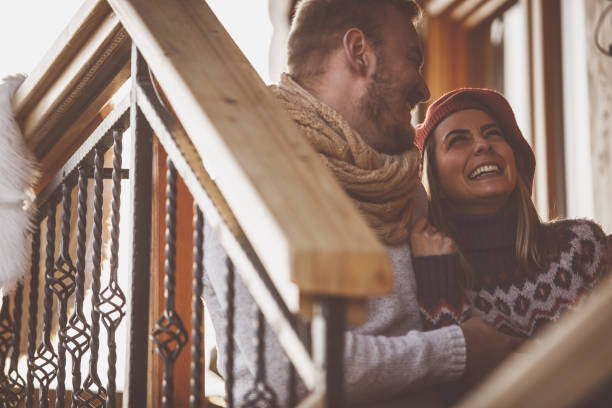istock Young man making his cheerful girlfriend laugh 1203715914