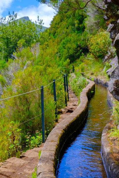 View over the mountains near Rabaçal and the Levada das 25 Fontes and Levada do Risco walkways on Madeira island during a beautiful summer day.