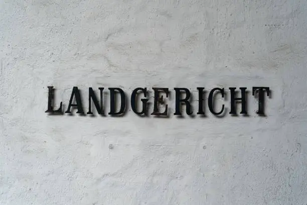 old lettering Landgericht in front of a white textured wall