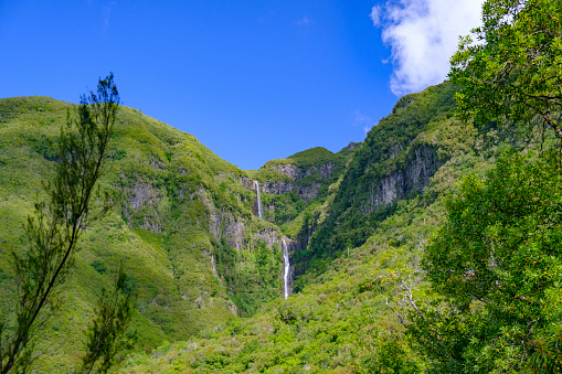 Risco waterfall in the mountains near Rabaçal and Levada do Risco and Levada das 25 Fontes walkways on Madeira island during a beautiful summer day.
