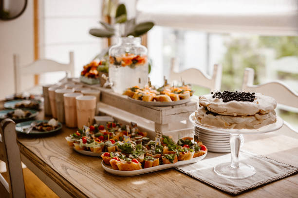 istock Dessert table for a party. White cake with blueberrys. Snacks on plate 1203716397