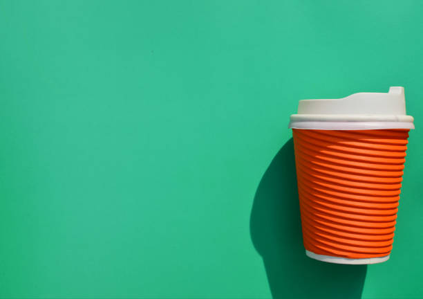 Disposable paper coffee cup with black lid in the air over yellow background. Minimal concept. 3D Rendering 3D Illustration