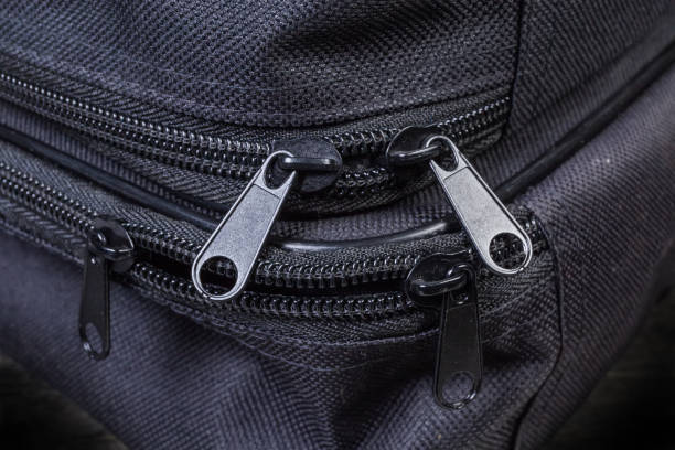 istock Plastic zippers each with two sliders on black bags closeup 1203717284
