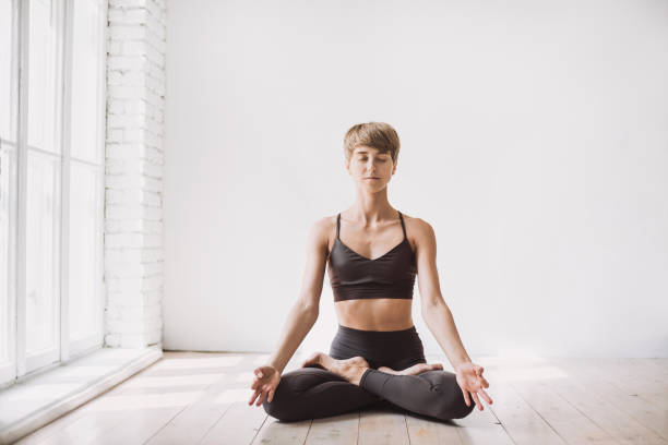 istock Young woman doing relaxation exercises at class. Yoga concept 1203717374