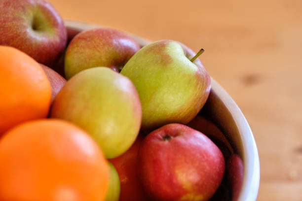 istock Fresh heap of delicious apples and oranges 1203718143