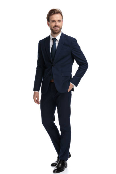 istock happy young businessman in navy blue suit smiling 1203718811