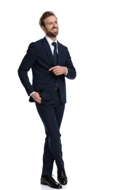 istock happy young businessman in navy blue suit smiling 1203719110