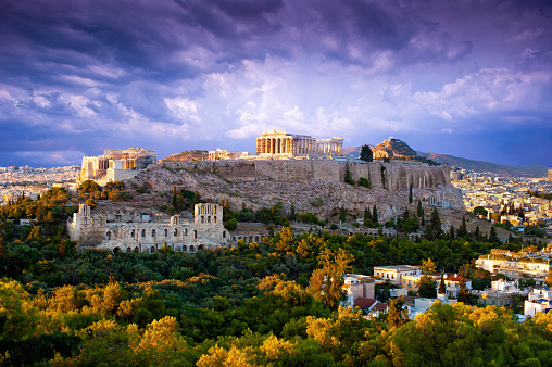 View of Parthenon Temple and Odeon of Herodes Atticus on Acropolis Hill at sunset, Athens, Greece