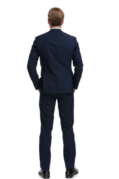 istock young businessman in navy blue suit holding hands in pockets 1203719357