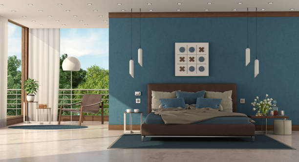 Modern blue master bedroom of a modern villa Modern blue master bedroom of a modern villa with leather double bed and armchair on background - 3d rendering royal blue curtains stock pictures, royalty-free photos & images