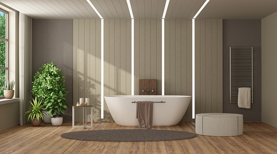 Modern home bathroom with bathtub against wooden paneling
