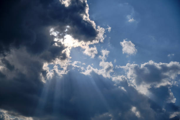 istock Storm clouds in a dramatic sky with breaking rays of the sun 1203720411