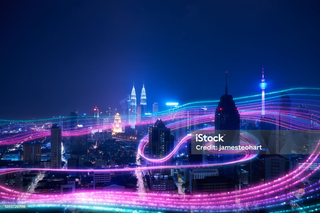 Smart city big data connection technology concept . Night city and abstract with gradient blue and red glowing light trail surround the city ,Smart city big data connection technology concept . City Stock Photo