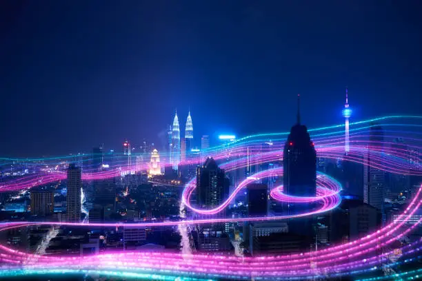 Night city and abstract with gradient blue and red glowing light trail surround the city ,Smart city big data connection technology concept .