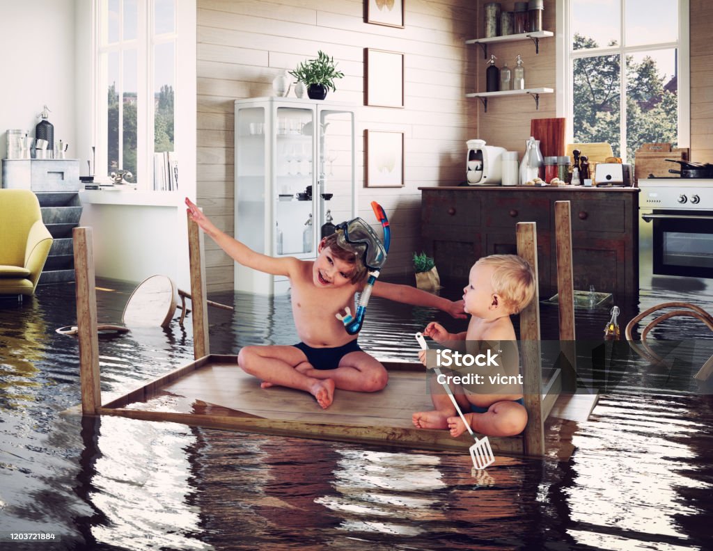 kids and flooding kids pday on the table while flooding in the kitchen. Photo and media photocombination Child Stock Photo