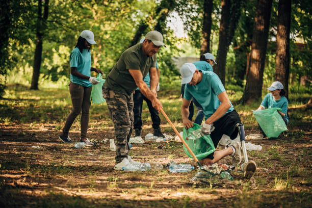 istock Volunteers cleaning garbage together in park 1203722269