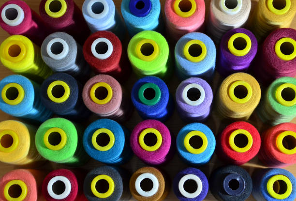 istock Background of bobbins with multicolored threads for sewing 1203723443