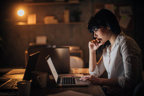istock One young business woman working late 1203723858