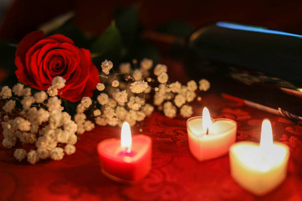 istock Red rose and wine in candle light 1203724220