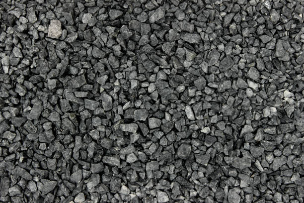 istock Gravel dark grey pebbles stone texture 1203724313