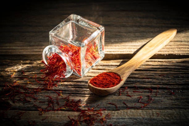 istock Saffron spice in glass bottle on rustic wooden table 1203725420