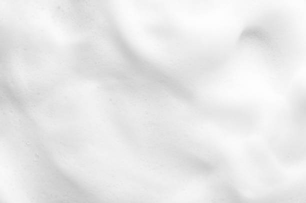 White foam texture close up background. Soapy substance with bubbles backdrop. Creamy grainy macro. Shower gel, washing liquid smears wallpaper. Cosmetic product foamy smudges top view White foam texture close up background. Soapy substance with bubbles backdrop. Creamy grainy macro. Shower gel, washing liquid smears wallpaper. Cosmetic product foamy smudges top view. snow white and the seven dwarfs photos stock pictures, royalty-free photos & images