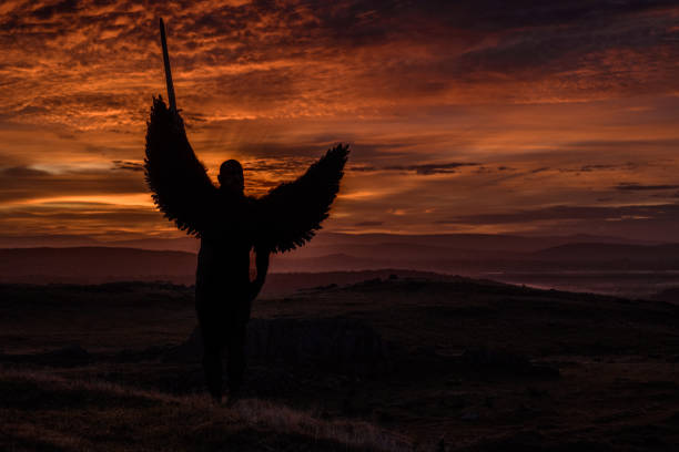 istock Black Winged Warrior Angel at dawn 1203727572