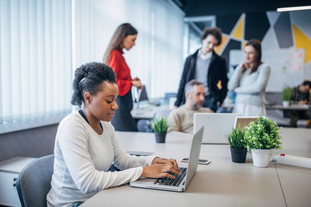 istock Diverse people working together in big modern office 1203727634