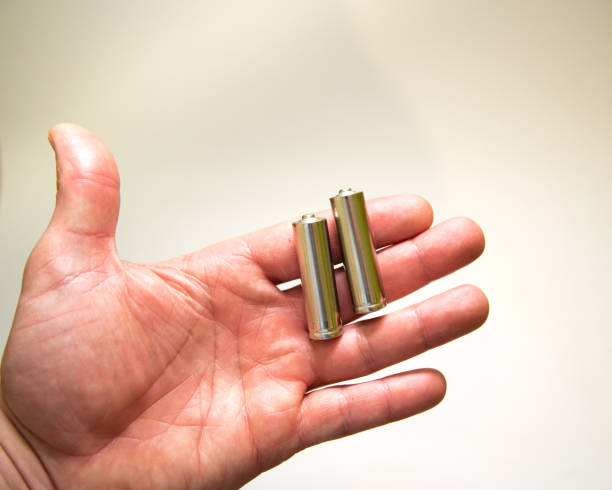 istock AA batteries in a man’s male hand 1203727670