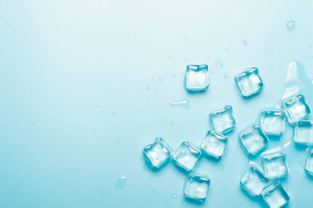 istock Ice cubes with water on a blue background. Ice concept for drinks. Banner. Flat lay, top view 1203728985