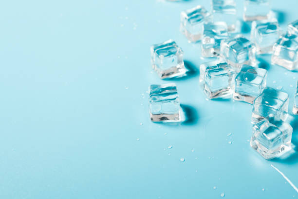 istock Ice cubes with water on a blue background. Ice concept for drinks. Banner. Flat lay, top view 1203729790