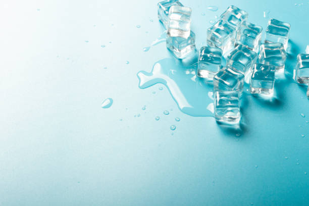 istock Ice cubes with water on a blue background. Ice concept for drinks. Banner. Flat lay, top view 1203729921