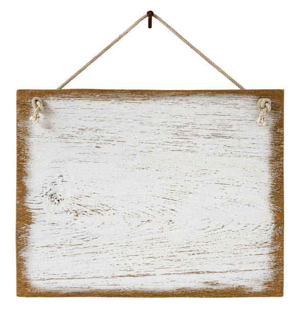 istock Old weathered worn white wooden board sign panel, hanging by old rope from a rusty nail, isolated on white, clipping path included. 1203730160