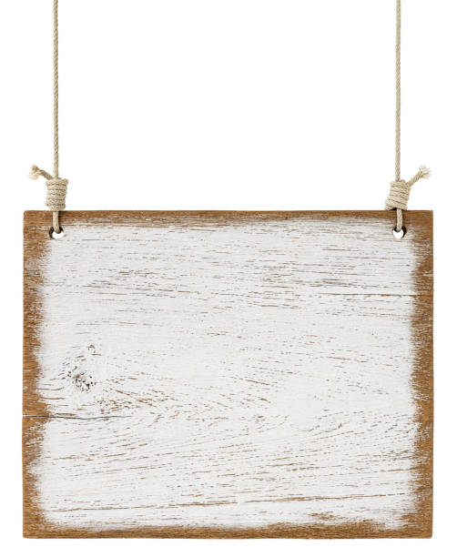 istock Old weathered worn white wooden board sign panel, hanging by old rope, isolated on white, clipping path included. 1203730230