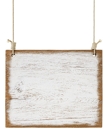 Old weathered worn white wooden board sign panel, hanging by old rope, isolated on white, clipping path included. The panel is very rustic with lots of weathering detail.