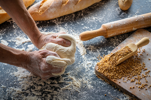 Baker man hands breadmaking kneading bread