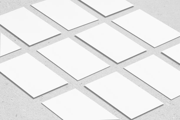 istock empty white rectangle business card mockups lying diagonally on neutral grey concrete background 1203731919