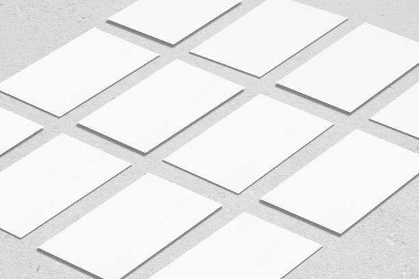 istock empty white rectangle business card mockups lying diagonally on neutral grey concrete background 1203731972