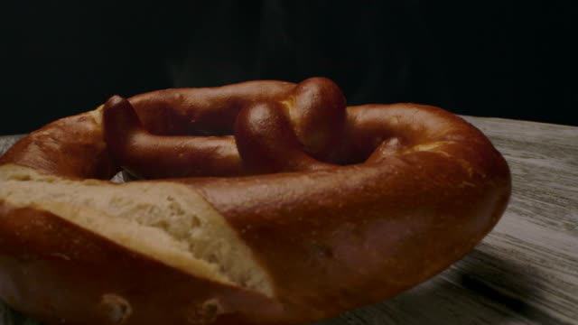 Hot pretzel placed on timber table