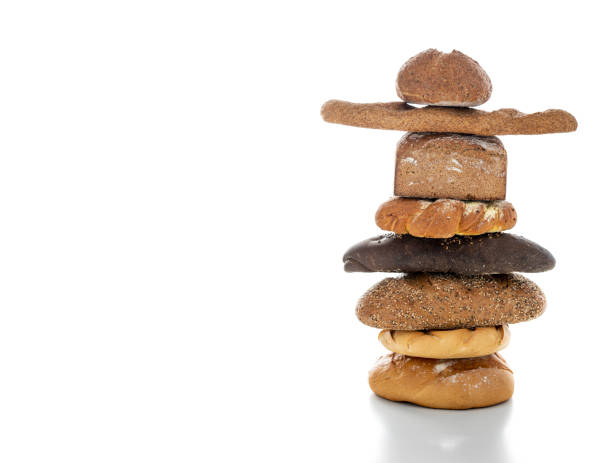 Bread baguette and bun stacked in column on white backgropund