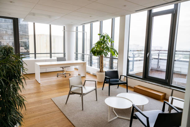 istock Modern corporate office sitting area with desk and view 1203732811
