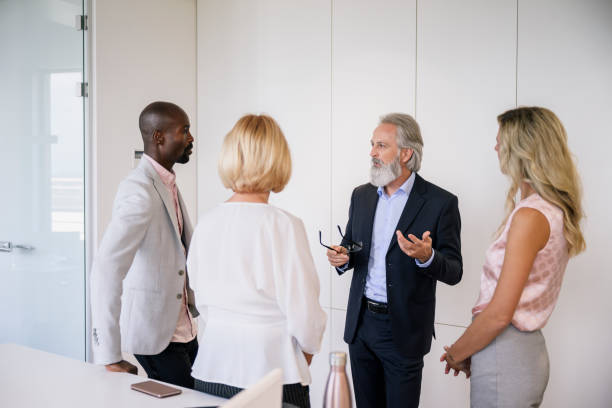 istock Business professionals sharing ideas in office lobby 1203732817