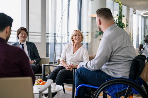 istock Young businessman discussing ideas with attentive group 1203732834