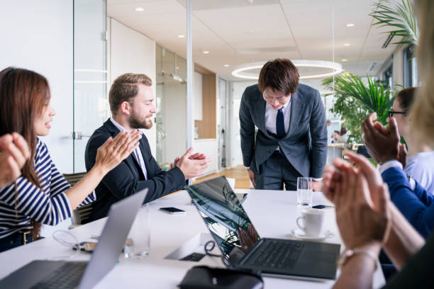 istock Young Japanese executive bowing in appreciation of applause 1203732891