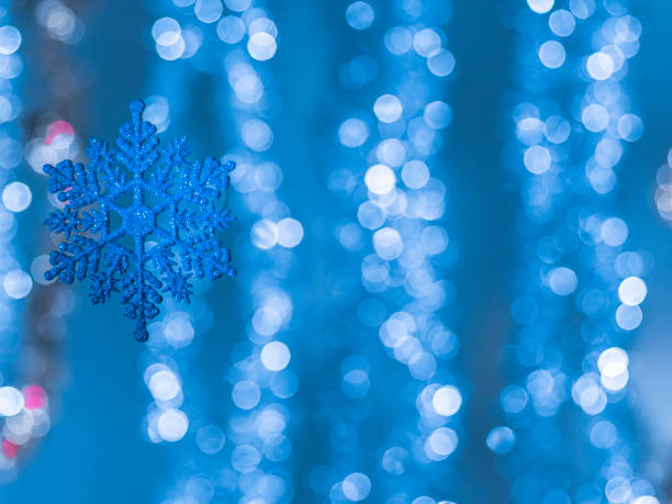 istock Floating christmas season star with bokeh elements in background with copy space on right side 1203733443