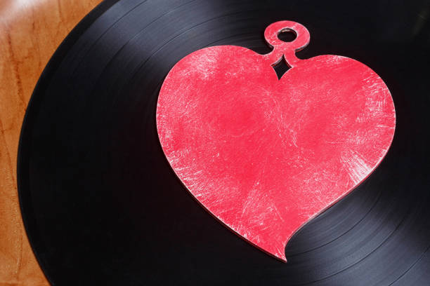 istock LP vinyl record with red heart. 1203734984